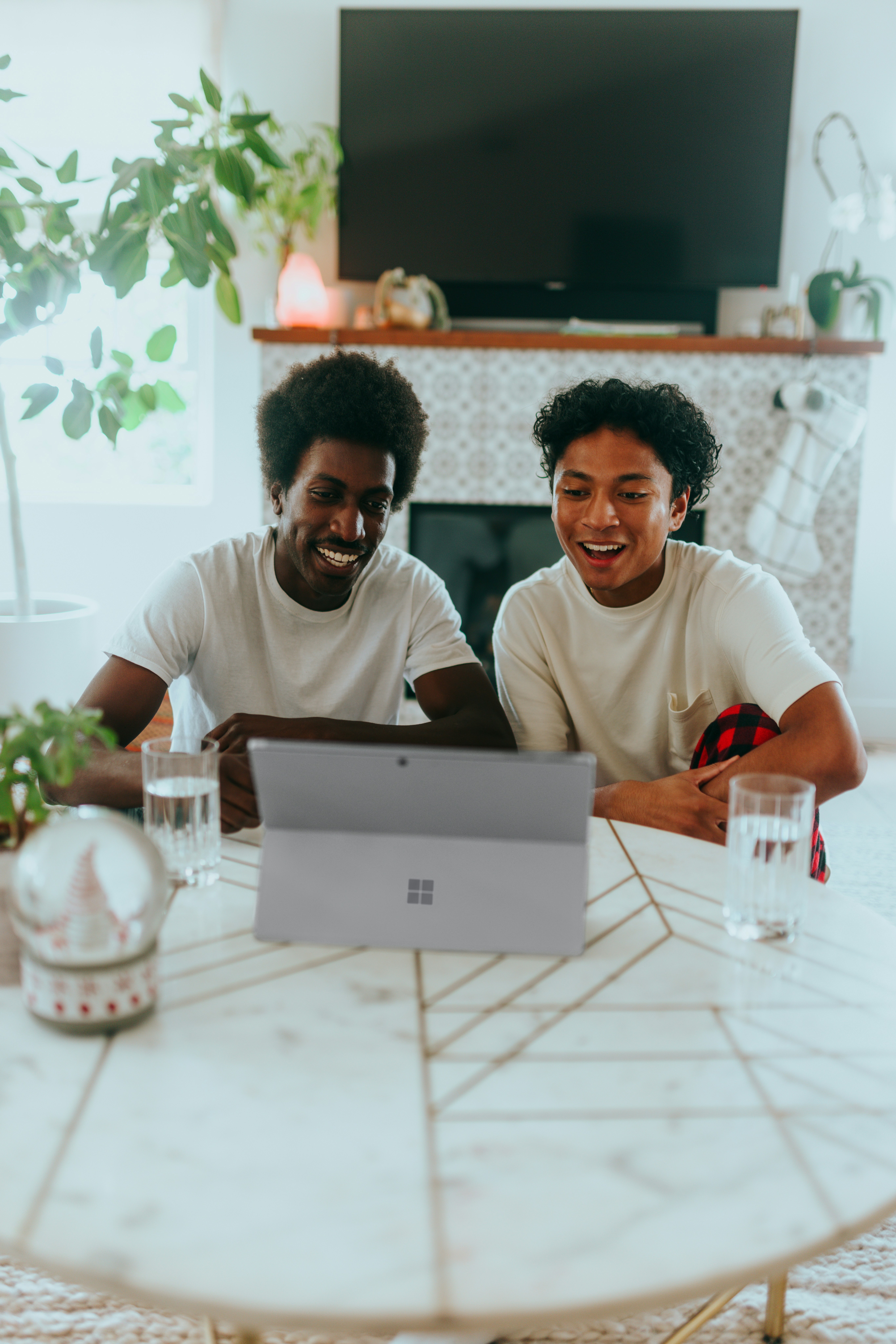 Young adult and mentor talking together over a laptop